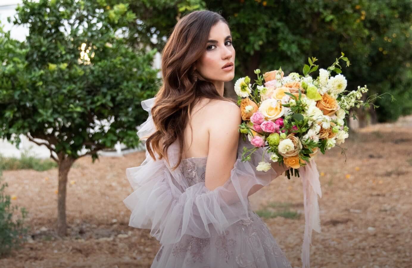Model wearing a gray gown by by Andrea & Leo